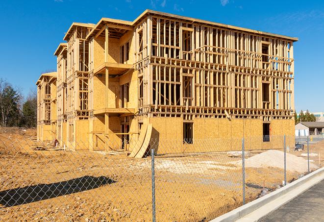 a close-up of temporary chain link fences enclosing a job site, signaling progress in the project's development in Haverhill FL